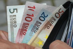 A man pulling euros from a wallet