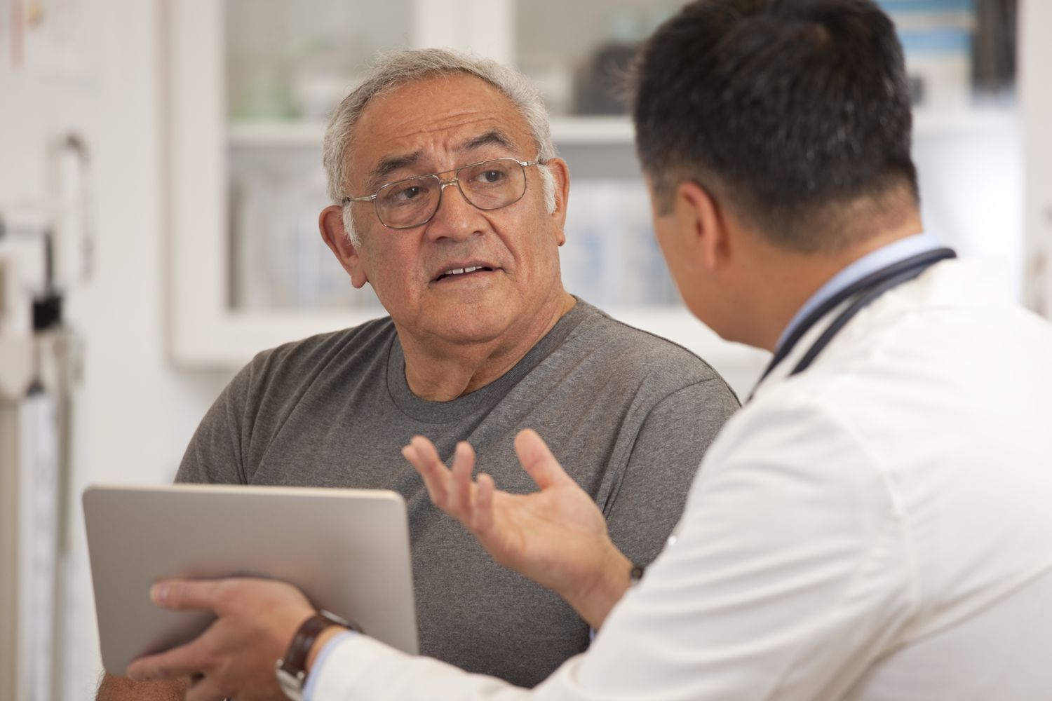 An older man talking to a doctor