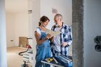 Older couple looking at tile flooring amid a home renovation.
