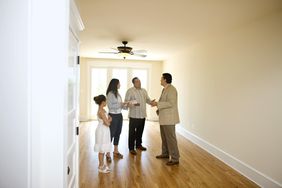 Family with realtor in new hom