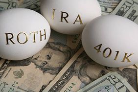 Roth, IRA, and 401K "nest eggs" laying on a bed of twenty dollar bills for retirement