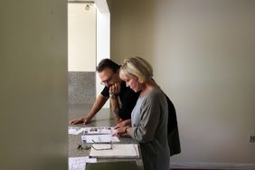 couple looking at house listings on counter
