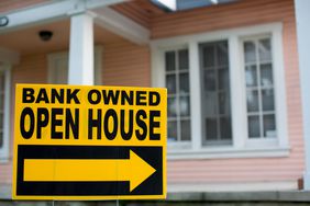 “Bank-owned open house” sign in front of a home