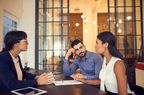 Shot of a young couple meeting with a financial planner in an office