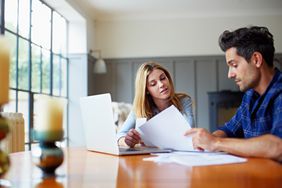 Couple going through some paperwork together at home