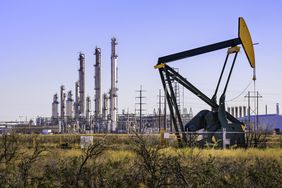 A pumpjack (oil derrick) and oil refinery in Seminole, West Texas.