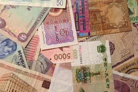 Paper currency from many different countries representing forex trading strategies.