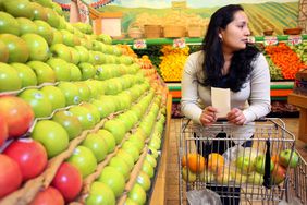 Woman shopping for produce at grocery store