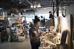 Female small business owner craftswoman working in workshop