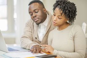 A husband and wife looking at their finances.