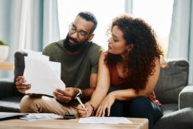 Young couple going over their finances together at home