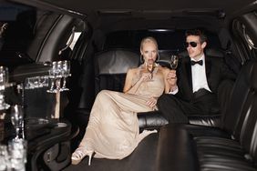 Well dressed couple in limo