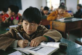 Young Asian student in a school room