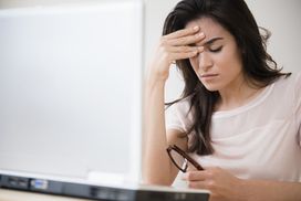 Frustrated woman checking credit score on computer