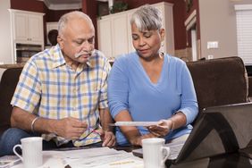 Couple reviewing tax paperwork at home