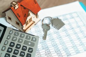 keys to home with budget sheet and calculator