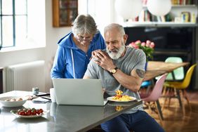 Mature couple reviewing finances at home