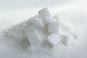 Heap of sugar cubes and granulated sugar