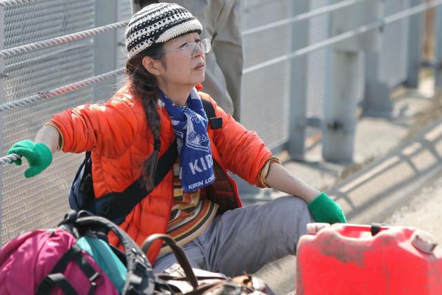 Resident sitting on ground after Fukushima earthquake
