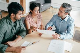 An attorney discusses a sale with his clients