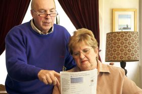 a senior couple reading social security form