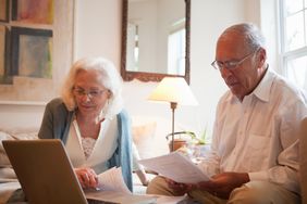Couple reviewing the beneficiary designation on their IRAs