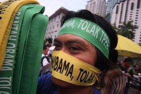 A protester wears a bandana that reads 'Reject Obama' during a protest against Trans Pacific Partnership Agreement (TPPA) outside the Global Entrepreneurship Summit on October 11, 2013 in Kuala Lumpur, Malaysia.