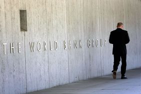 Man walking in front of the World Bank Group building in Washington
