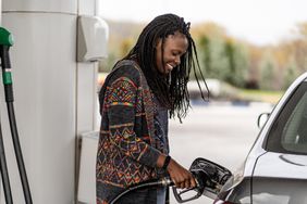 Consumer at the gas station refueling car