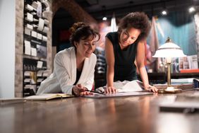 Two business owners look over business plan in office